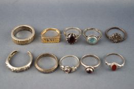 A collection of ten silver rings of variable designs with gem set and plain. One is 925 gold plated.