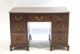 A Georgian style mahogany rectangular desk with rounded edges,