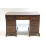 A Georgian style mahogany rectangular desk with rounded edges,