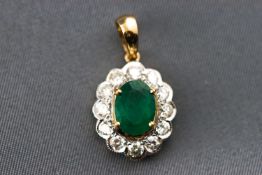 A modern yellow metal cluster pendant set with an oval faceted cut emerald