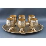 Six Indian white metal tot cups,