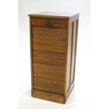 A tambour fronted hardwood music cabinet of upright rectangular form stamped "Orda Ltd",