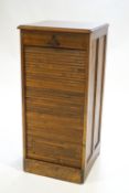 A tambour fronted hardwood music cabinet of upright rectangular form stamped "Orda Ltd",