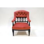 A Victorian nursing chair with button back and upholstered arms,