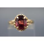 A gold plated silver dress ring set with a single rhodolite garnet. Stamped Silver & GP. Size: M.