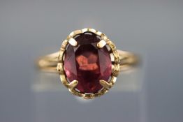 A gold plated silver dress ring set with a single rhodolite garnet. Stamped Silver & GP. Size: M.