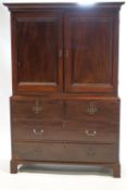 An 18th century mahogany linen press style cabinet on chest,