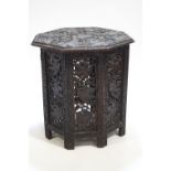 A Middle Eastern hardwood octagonal table profusely carved