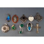 A collection of ten silver pendants of variable designs to include gem set and plain.