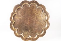 An Indian brass tray, of lobed form, decorated with figures,