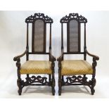 A pair of carved hardwood Daniel Marot style armchairs with pierced cresting rails