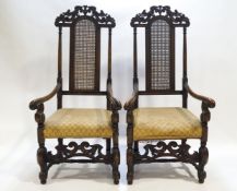 A pair of carved hardwood Daniel Marot style armchairs with pierced cresting rails