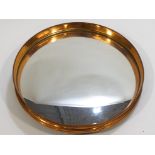 A copper framed convex mirror,