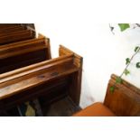 A Victorian pine pew with triple paneled back and prayer book shelf to reverse with one wall end