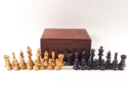 A turned wood chess set in a mahogany box