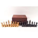 A turned wood chess set in a mahogany box