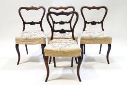 A set of four Victorian rosewood dining chairs with carved back rails