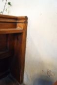 A Victorian pine pew with triple paneled back and prayer book shelf to reverse with one wall end