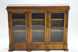An early Victorian walnut three door side cabinet,