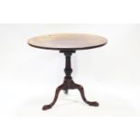 A George III style mahogany tripod table, with bird cage top to pedestal base, 73.