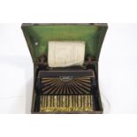 A cased Odeon accordion in green mother of pearl effect finish