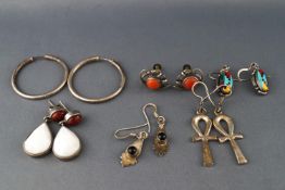 A collection of six pairs of silver earrings of variable designs.