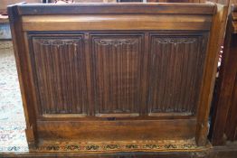 A Victorian oak prayer book stand with triple linen fold paneled front 80cm high, 101cm wide,