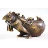 A signed Japanese metal figure of a rat pulling a Hotei sack covered in its young,