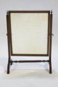 A mahogany rectangular swing mirror, in the Georgian style,