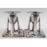 A pair of Archibald Knox style pewter candlesticks,
