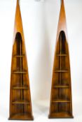 A pair of shaped wooden bookcases in the form of skiff prows, each set with five shelves,