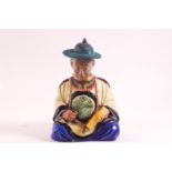 An earthenware figure of a seated Chinese gentleman,