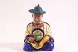 An earthenware figure of a seated Chinese gentleman,