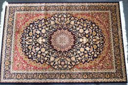 A machine woven Zeigler carpet with central medallions and scrolling flowers on a blue ground