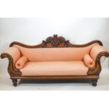 A mid 19th century carved mahogany double ended sofa with bow shaped back