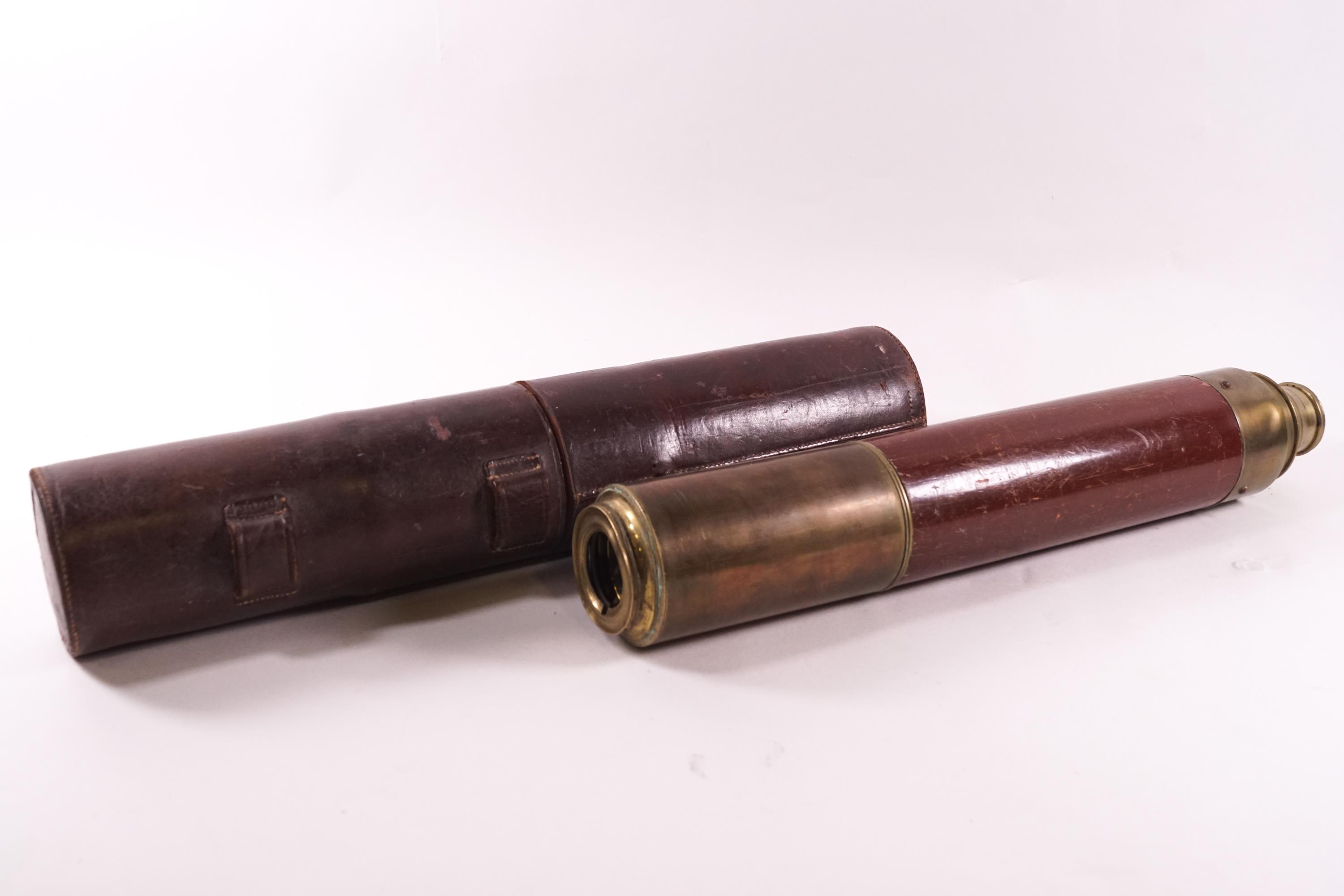 A leather cased brass and mahogany three pull section telescope (un-signed).