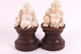 A pair of early 20th century ivory figures, of the laughing Budai, 4cm high,