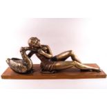 An Art deco cast plaster statue of Leda and the swan, with a graduated painted gold finish,