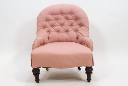 A 19th century button backed nursing chair raised on turned legs,
