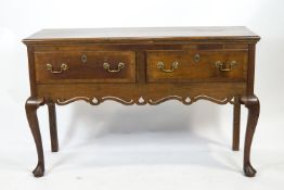 An oak dresser base of early 18th century provincial form,