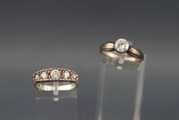 A collection of two white metal dress rings each set with colourless cubic zirconia.