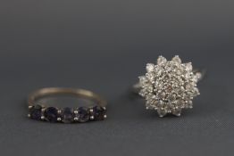 A white metal cubic zirconia cluster ring together with a white metal amethyst half hoop ring.