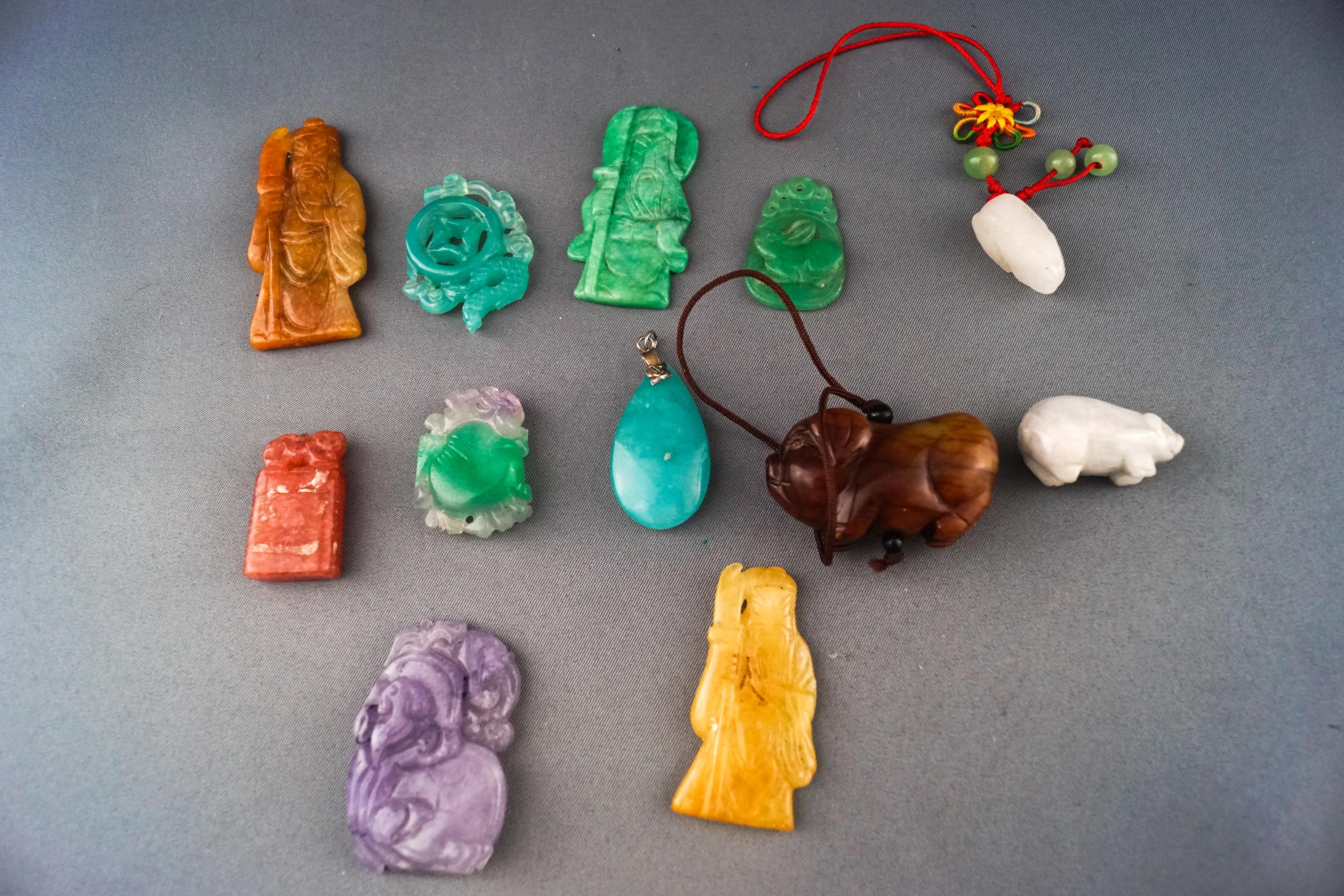 A group of twelve hard stone/jade carvings and pendants. Gross weight: 128..6 grams