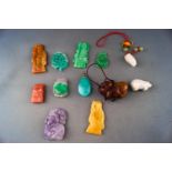 A group of twelve hard stone/jade carvings and pendants. Gross weight: 128..6 grams
