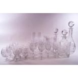 A part suite of cut glass, comprising of three decanters and stoppers, six wine glasses,