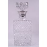 A rectangular cut glass decanter and stopper, with silver collar, by Garrard & Co,