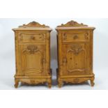 A pair of French pine contraposed bedside cupboards with shell carved back rail