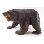 A Black Forest/Russian hardwood style carving of a snarling bear on all fours,