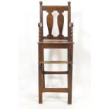 A late Georgian child's high arm chair in oak and elm, peg constructed in the traditional manner,