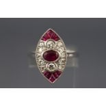 A white metal dress ring. Set with an oval faceted cut ruby to centre.